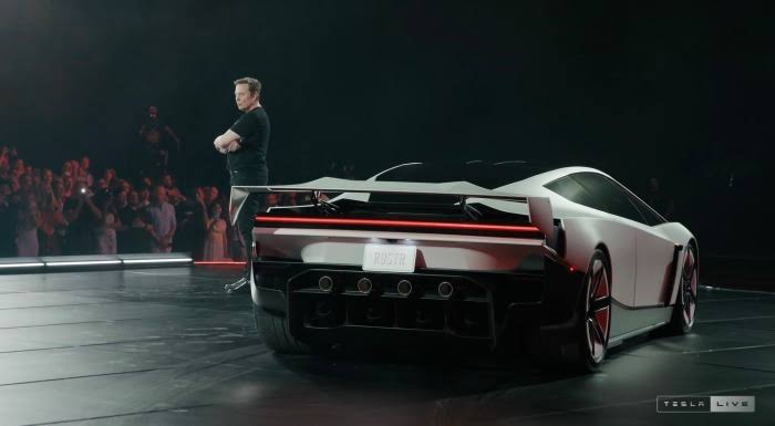 Elon Musk presenting the new Tesla Roadster rocket car prototype at the SpaceX test facility